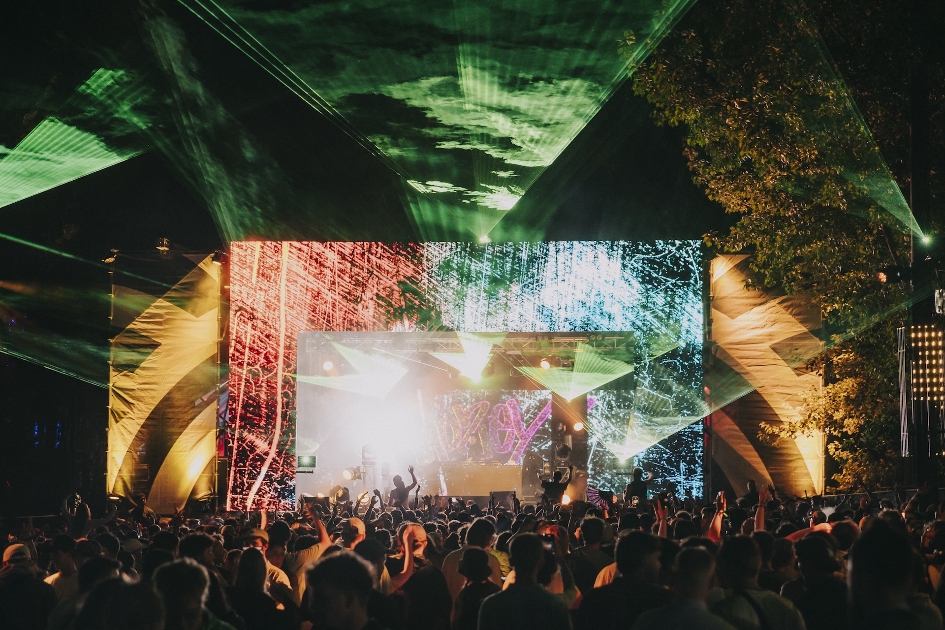 Northern Bass festival crowd enjoying the vibrant Jungle Stage with dramatic lighting and production